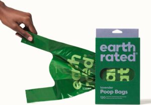 Hand pulling poop bag out of box